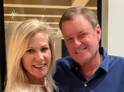 Devin Doyle smiling with his wife at an indoor event