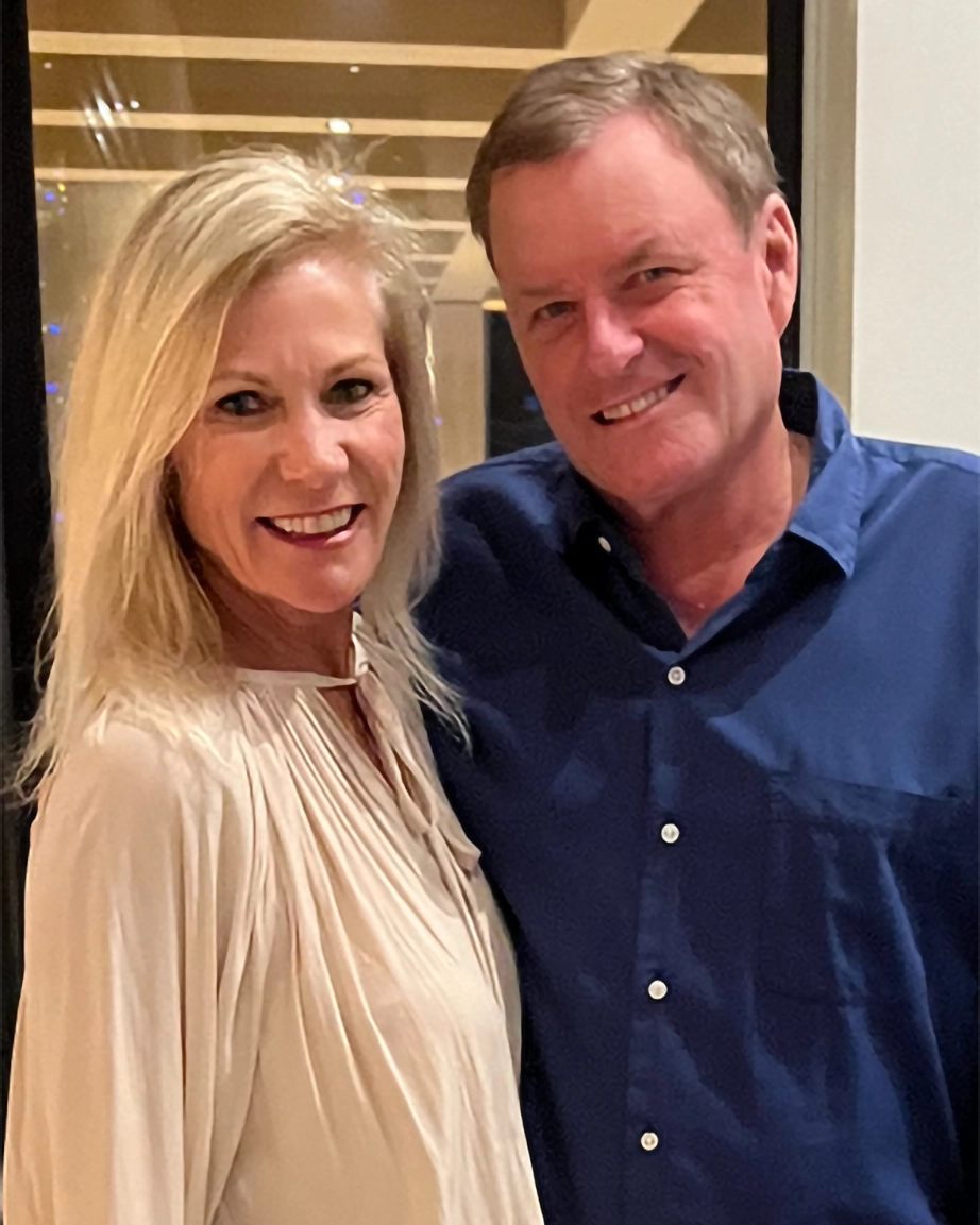 Devin Doyle smiling with his wife at an indoor event